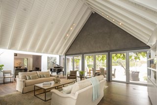 The entire rear of the living room opens up to the back patio, creating an integrated entertainment space. Van Scoter describes seating 100 people for dinner between the indoor and outdoor areas.