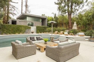 A pool and hot tub divide the main house from the pool house, which has two showers, storage space, and utilities—making it an ideal guesthouse or in-law unit.