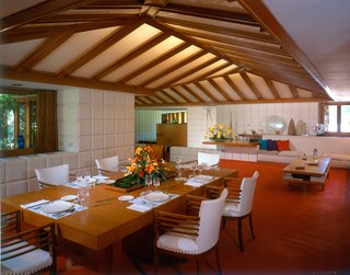 Alden B. Dow: The Mastermind of Midwestern Modernism - Photo 6 of 7 - A red-orange carpet sets the stage for the dining area. Here, Dow taught his children lessons about honesty, humility, and enthusiasm—three values integral to all structures. Honesty refers to the straightforward use of materials to meet a need, while humility encourages a balance between buildings and their surrounding environment. Enthusiasm is "the real life-giving property...the quality that makes buildings more than a box," expressed Dow.