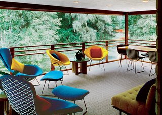 Alden B. Dow: The Mastermind of Midwestern Modernism - Photo 7 of 7 - Bird Chairs, Diamond Chairs, and Dining Chairs by Harry Bertoia provide ample seating on this cantilevered porch, which is screened in by a delicate copper mesh and provides views of the expansive Dow Gardens—connected to the studio by an Asian-inspired footbridge.