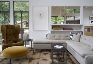 A Northern Californian Renovation Brings Warmth to the Wilderness - Photo 2 of 6 - The living room features furniture from BDDW. Much of art arrayed throughout the home was collected through auctions; Southern Exposure and The Luggage Gallery are two favorite sources.