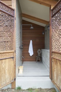 A Northern Californian Renovation Brings Warmth to the Wilderness - Photo 5 of 6 - The home offers places for solitude and quiet. "Each bedroom was thought of as a separate building," says the homeowner. "Each bathroom had an outdoor component." Here, an outdoor shower is a private connection to the outdoors.