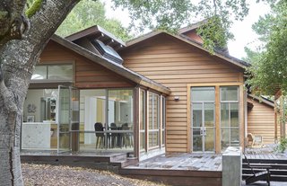 A Northern Californian Renovation Brings Warmth to the Wilderness - Photo 6 of 6 - Part of what drew the homeowners to the house was its quality redwood construction. An outdoor deck provides an intermediary space that connects the interior to acres of open meadow.