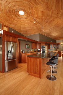A Round Pennsylvania Prefab Offers 360-Degree Solutions in Sustainability - Photo 3 of 7 - Empowered to act as his own general contractor with Deltec Homes' support, Sanders cut wood from his own property for the ceiling, trim, and cabinetry—drying, forming, and finishing the material on site.