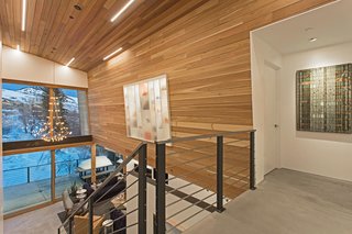 A Plunging Roof Carves Out Space in This Park City Home Offered at $2.4M - Photo 5 of 9 - "Having walls for art was a huge consideration in the design," says Mullin. Upstairs, a shoe and purse display case creates a shadowbox effect.