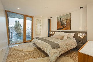 A Plunging Roof Carves Out Space in This Park City Home Offered at $2.4M - Photo 6 of 9 - The master bedroom has access to a private terrace with alpine vistas.