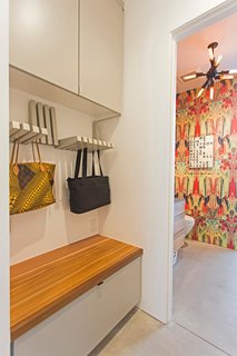 A Plunging Roof Carves Out Space in This Park City Home Offered at $2.4M - Photo 8 of 9 - A clever storage area holds purses and bags, while a bench hides away bulkier items.
