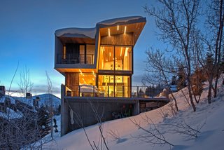 A Plunging Roof Carves Out Space in This Park City Home Offered at $2.4M - Photo 9 of 9 - The shou sugi ban exterior siding stands as a bold contrast in the snow, and is "bulletproof in the hot desert summer," says Mullin.