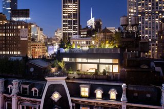 A Rooftop Addition on a 19th-Century Building Suits a Growing Family’s Needs - Photo 9 of 9 - Contemporary materials like zinc and glass contrast with a cast iron facade and slate roofs.