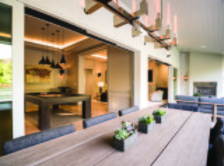A renovation in the Pacific Palisades neighborhood of Los Angeles connects the living and family rooms with a covered porch through a series of Ultimate Multi-Slide Doors.