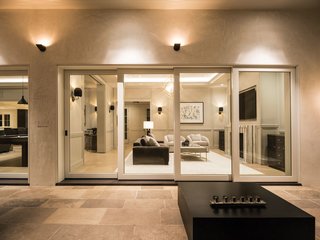 A Los Angeles Renovation Opens Up to Coastal Climes - Photo 1 of 3 - "What Marvin offered us in terms of design, style, and cost fit the project the best," says Ungar. Here, Ultimate Multi-Slide Doors allow the living room to give way to a spacious covered patio. Low-maintenance with a U-factor of 0.28, the doors are durable while offering excellent thermal performance.