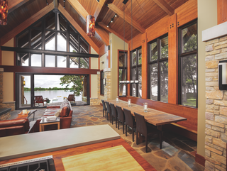 This home merges an open living space with a serene porch overlooking the water with a Marvin Ultimate Multi-Slide Door. 