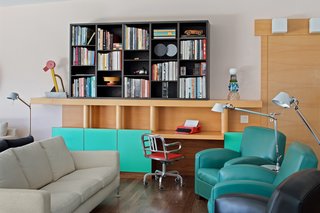 Custom built-in furniture is found throughout the home, such as this piece in the living room. Sottsass's Tahiti lamp, an abstracted and geometric bird shape, was designed for the 1981 Memphis collection, and his Valentine typewriter for Olivetti turned a piece of office equipment into a fashion accessory. 