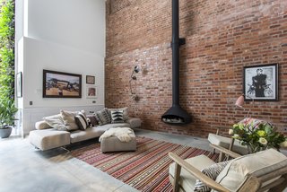 Formerly the site of a French polishing company in the 20th century, this building in Clerkenwell, London, was converted by Chris Dyson Architects in 2015 into a residence with an expanded basement and triple-height living space that allows a dramatic feature staircase to take center stage.