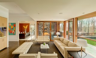 The family room enjoys broad views of the landscaped property and leads to an outdoor terrace and fireplace.