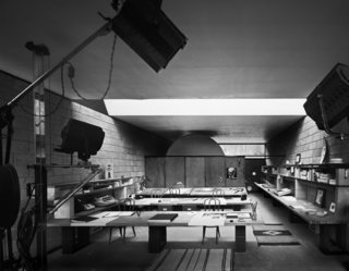 An archival photo shows the interior of the detached studio with drafting tables awash in light through the enormous skylight above.