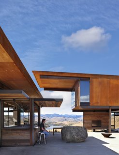 The walls of the bar open up, giving it a playful "Coney Island aspect," says Kundig. "It has turned out to be a particularly successful part of the architecture." Outside, a boulder reasserts the landscape—and serves as creative seating.