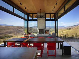 The living room features glass walls that open up to the scenery, eliminating the barrier between interior and exterior.