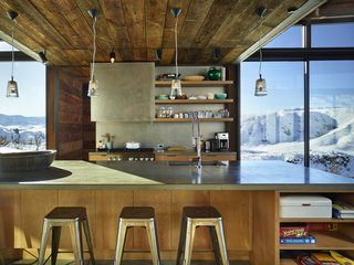 Wood siding salvaged from an old barn in Spokane, Washington, was repurposed for the project. "The varying tones of the wood reveal its history and use," says Kundig. Throughout the home, common materials are employed in fresh ways, such as exposed plywood used in the flooring and walls.
