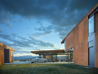 The courtyard-facing side of the garage provides an overhang for a multifunctional playroom or entertainment space.