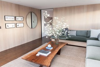 The penthouse living room and bar by Catherine Kwong features a Nakashima Cocktail Table. Kwong flew to Pennsylvania to meet with George Nakashima's daughter, Mira, and selected the slab of walnut that would anchor the room. "That was the first design decision made, and everything else followed," says the designer.