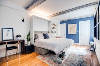 This peaceful, rustic bedroom makes use of a Murphy bed by Resource Furniture with a couch in a three- or two-seat version and integrates with closet and shelving systems.