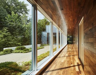 An Accessible Home Promotes a Lifetime of Well-Being For the Whole Family - Photo 3 of 7 - A stunning wall of windows creates a cloister-like feel adjacent to the main courtyard. The outdoor spaces "offer an ever-changing play of shadow and reflection as the motion of the sun, changing seasons, and weather interact with carefully designed landscapes," describes Rappe.