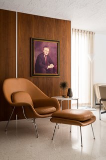 A Knoll Womb Chair is the perfect place to lounge off the living room. The homeowners replaced nine types of flooring—including linoleum and green shag carpeting—with terrazzo tiles and carpet in the bedrooms. 