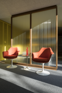 A pair of Saarinen Tulip Armchairs offers front-row seats to an ever-changing view from the bedroom, which benefits from floor-to-ceiling windows.