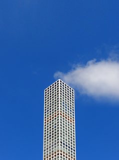 The Smoking Building. A well-placed cloud gives the impression that this New York City building is emitting steam, a visual metaphor for the hot real estate market.