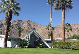 With a triangular A-frame front, similar to that of a Swiss ski chalet, the Swiss Miss houses were designed by Charles Dubois in a section with about 15 other homes just like it. The unusual front spans two-stories tall giving the home some dramatic curb appeal.