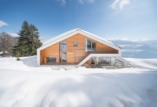 Inspired by traditional chalets of the Swiss Alps, Dutch architects SeARCH designed this 500-square-meter home as a single, visually clear volume with wood cladding and decidedly modern glazing and windows.