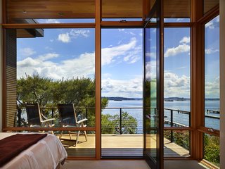 Take it Outside With These 11 Spring-Friendly Deck Spaces - Photo 6 of 11 - The entrance to this lakefront home is a serene courtyard with plenty of privacy. By removing much of the main floor structure, the main living spaces open to terraces, gardens, and sweeping views