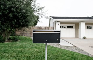 A modern mailbox in the front landscape provides character that emphasizes the overall minimal aesthetic. 
