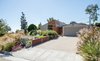 Modern home with Outdoor, Front Yard, Hardscapes, Walkways, Boulders, Trees, Flowers, Wood Fences, Wall, Large Patio, Porch, Deck, Horizontal Fences, Wall, Landscape Lighting, Garden, and Slope. Changing the vehicular approach provides for direct garage access and allows for the drought-tolerant landscaping to contribute to both privacy and an enhanced streetscape. Photo of A California Ranch Home, Reimagined