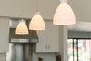 Minimal pendants add warm, intimate lighting at the oversized kitchen island. Photo 9 of A California Ranch Home, Reimagined modern home