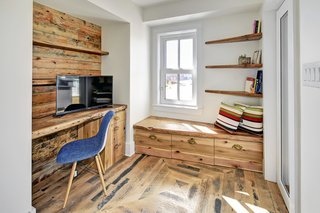 This office space also boasts reclaimed barn wood and features a built-in desk and storage tucked away under the built-in bench. 