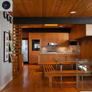 Dining area and Kitchen. Built in seating for both dining and wine rack and poured in place concrete counters/backsplash. Custom alder cabinets designed to wrap around the beams.