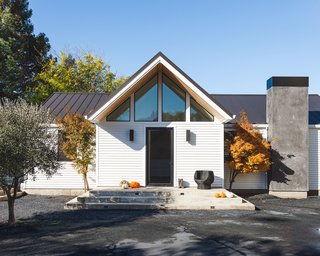 Originally built at the turn of the last century, this modest country house had traditional closed-off rooms and small windows facing the large lot with various outbuildings. The house was expanded by adding a master suite in a complementary shape. The existing portion of the home was modernized by opening the floor plan, modifying rooflines and adding large sliding doors to connect to the outdoors visually and physically. 