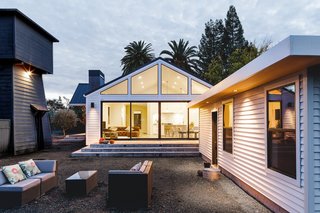 In Sonoma, California, a historic farmhouse receives a contemporary makeover. Large sliding doors allow for seamless indoor-outdoor connection. 