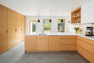 Custom-made white oak cabinetry provides a sleek contemporary look and minimalist interiors.