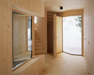 The entryway folds where the two wings meet, creating a V-shaped front door and window.