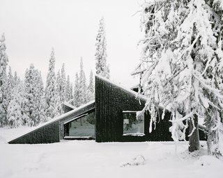 The cabin’s concept was simple: To create a cabin that is small and sparse yet spatially rich. The 55-square-meter (592-square-foot) cabin, commissioned by a private client and completed in 2016, comprises a large living room, bedroom, ski room, and small annex with a utility room. It functions off the water and electricity grids.
