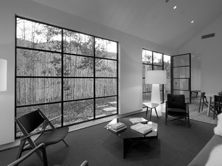 The big window and door in the living room provide a connection to the aspen trees outside.
