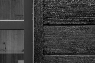 Charred cedar wood gives the cottage’s exterior a rough, bark-like texture