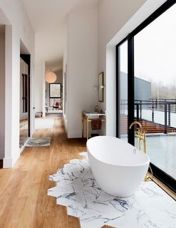 It might look complicated, but Studio DB's Britt and Damian Zunino, the duo behind this stunning bathroom space, say transitioning tiles to wooden floorboards is surprisingly straightforward. "The first step is getting your contractor on board, but the actual work isn't that complicated," they told MyDomaine. 