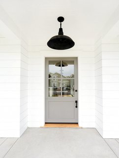 If you feel most at home in neutral territory, you may want to consider going gray. Take this door for example: An earthy gray color sets a relaxing, inviting tone that makes pretty much anyone want to step inside.