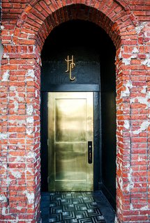 This metallic gold door shines bright to welcome guests to L.A.'s Hotel Covell. Against a backdrop of more textural, aged elements—like the brick wall—it's a smooth, glam touch.