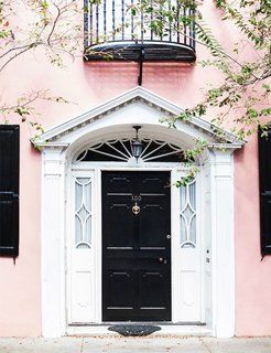 Knock, knock. Who’s there? A fresh front door color combination. It doesn't get more classic that a jet-black front door, but in this case, the blush walls give the traditional shade a trendy new twist.