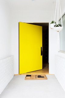 This vibrant, happy shade of yellow invites the sunshine (and sunny vibes) in. That's what makes yellow one of my favorite colors. Accessorized with a simple welcome mat and a few hanging plants, this bright door only requires minimal décor to make a big opening statement. 